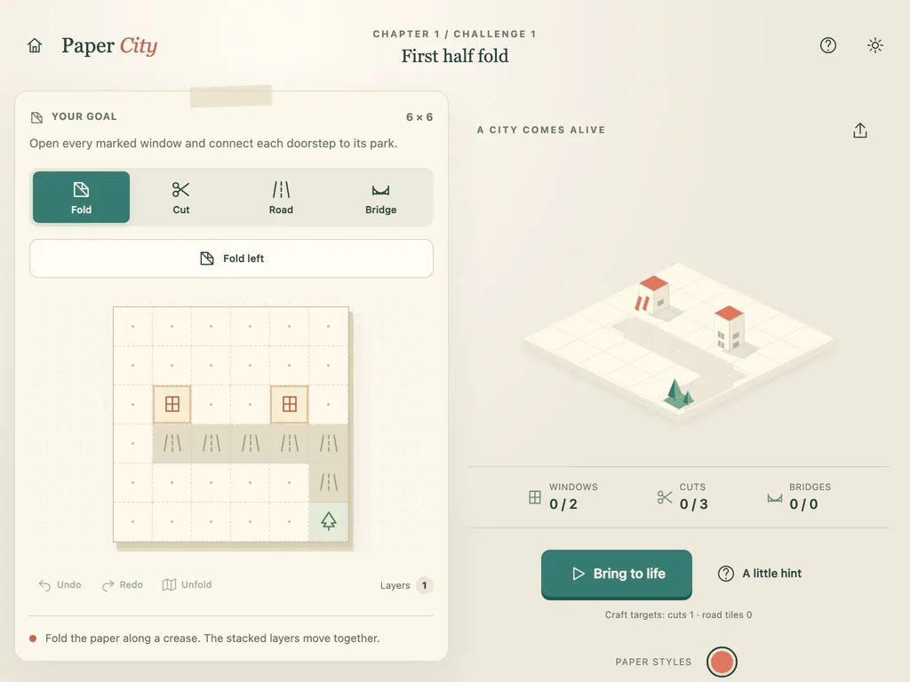 Paper City on a tablet-width screen, with the fold-and-cut workbench beside the paper town